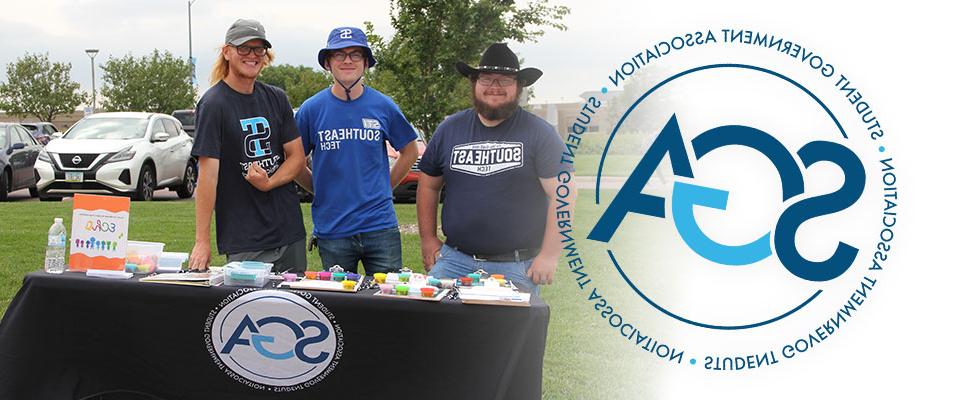 SGA logo and members at registration table